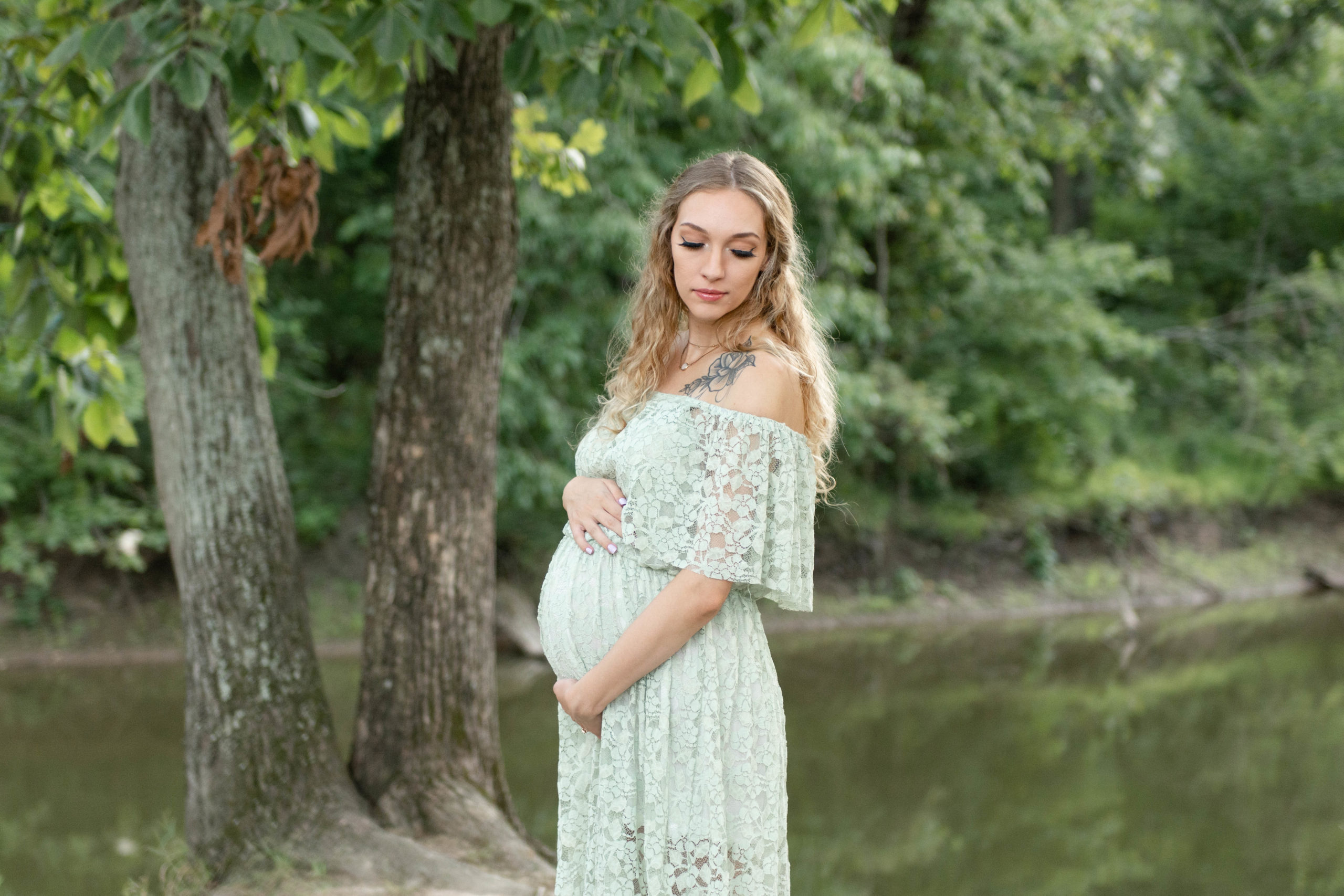 Client poses for maternity session