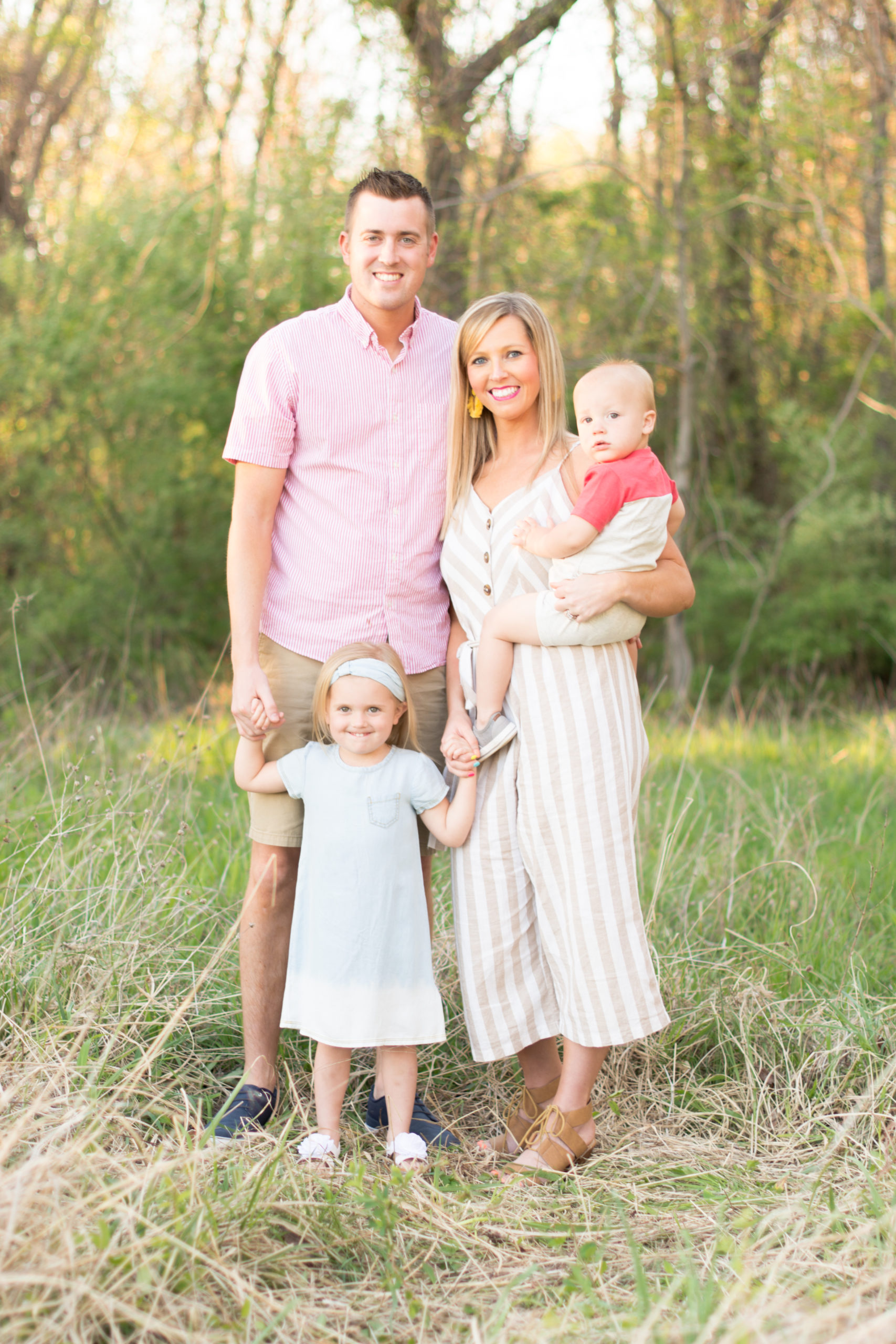 Family poses in field for their spring session